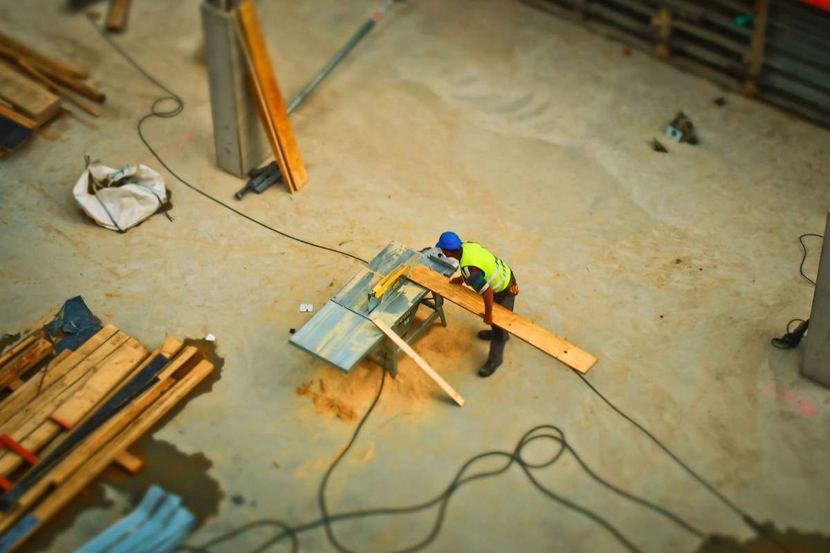 Contractor reviewing a website mockup on a laptop at a job site