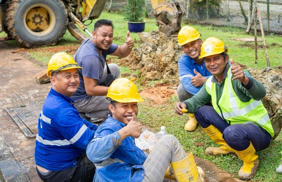 Construction crew smiling on a job site