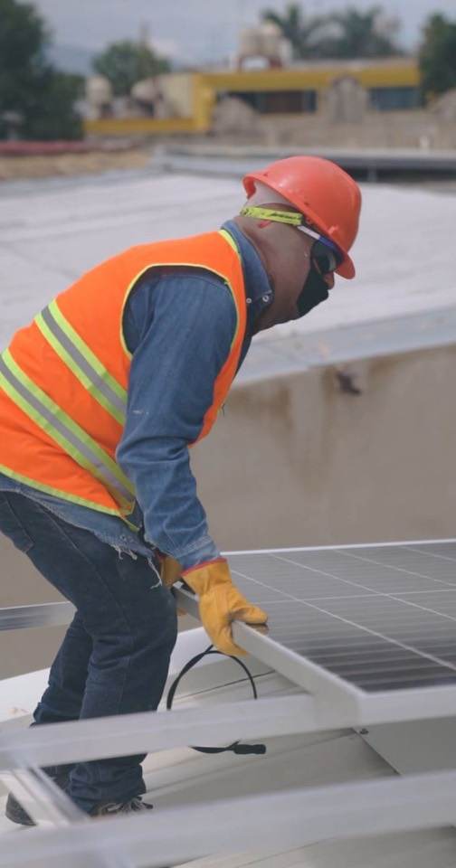 Roofer at work in a high-visibility vest