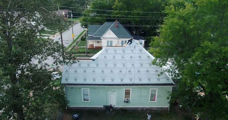 Aerial view of a house with a new metal roof